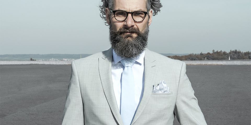 Man in a gray jacket with Shells pocket square and tie Man in a gray jacket with Shells pocket square and tie